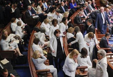 House Democrats wearing white took their seats on Tuesday night before President Trump's speech to a joint session of Congress