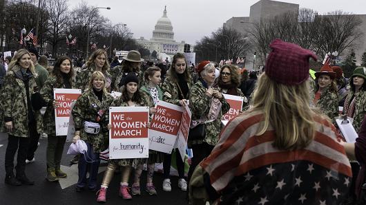 Protestors during the Women's march in Washington. They hold placards saying 'We the women March for humanity&#039