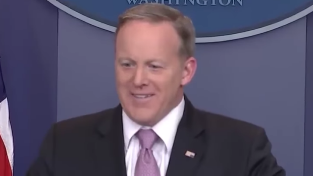 Press Secretary Sean Spicer talk to the media while wearing an upside down American flag pin- a sign of distress