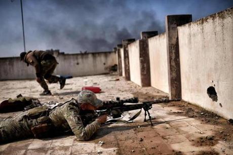 A sniper fired during clashes with Islamic State fighters in Mosul Sunday during an offensive to retake parts of the city