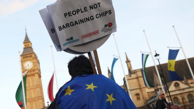 A demonstrator holds a placard during a protest in favour of amendments to the Brexit Bill outside the Houses