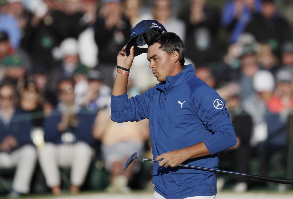 Masters Golf Rickie Fowler tips his hat on the 18th green after shooting a 5-under 67 the low round of the second day