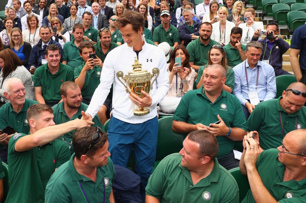 Murray poses with the trophy after beating Milos Raonic to claim his second Wimbledon title in 2016