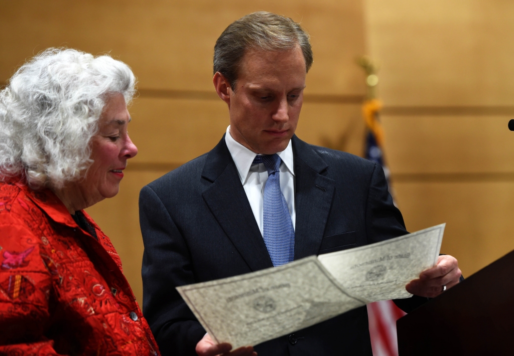 Secretary of State Steve Simon right examines the ballots of 8th Congressional District elector Mary Murphy as Minnesota's ten electoral college voters cast their ballots for President and Vice President of the United States at the Minnesota Senate Bu