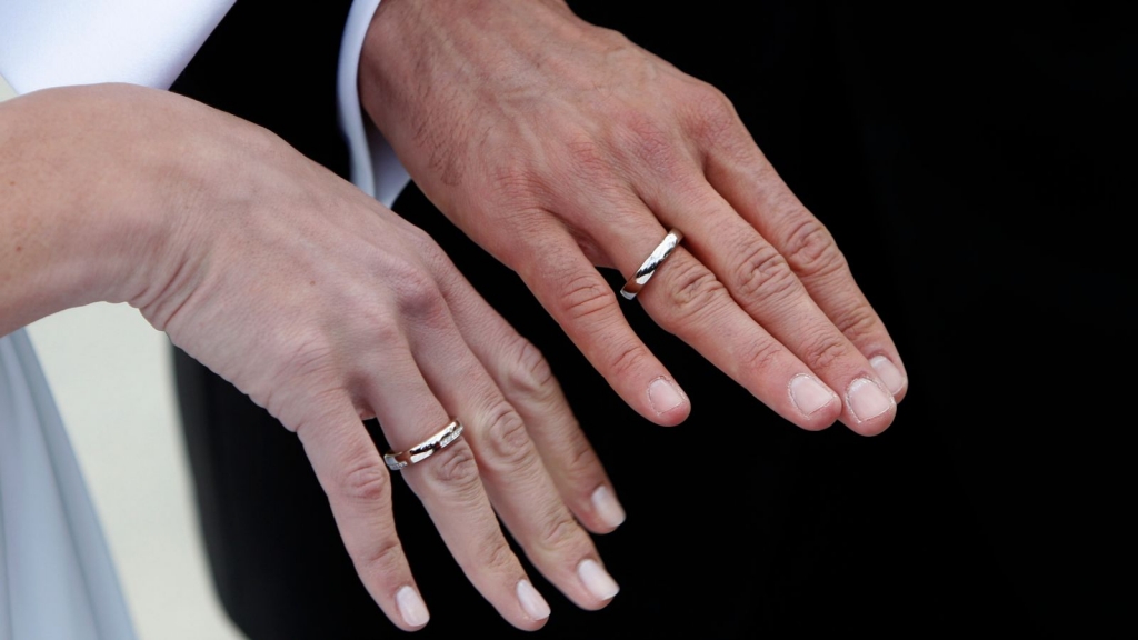 Man and woman showcase wedding rings