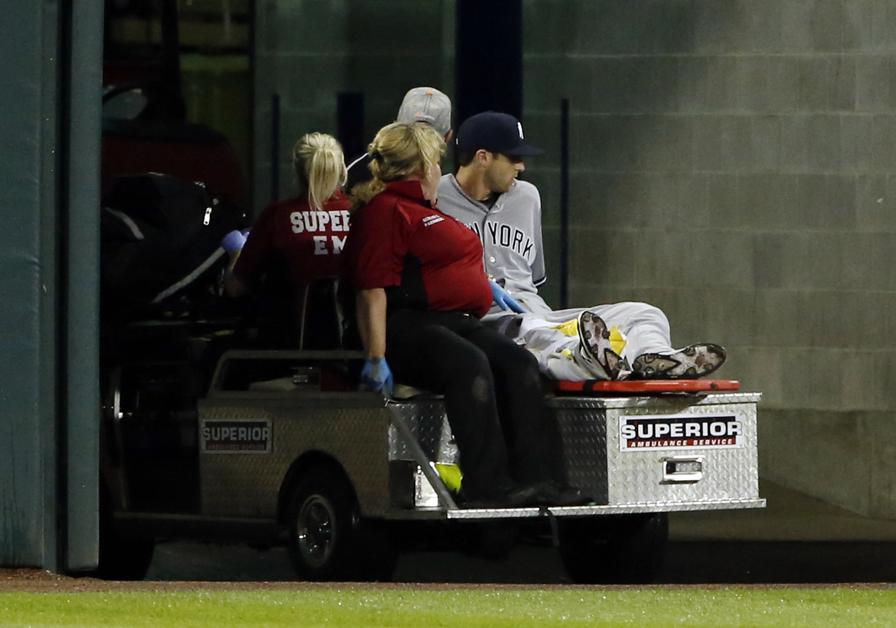 New York Yankees Dustin Fowler is taken off the field after he was injured during the first inning of the team's baseball game against the Chicago White Sox on Thursday