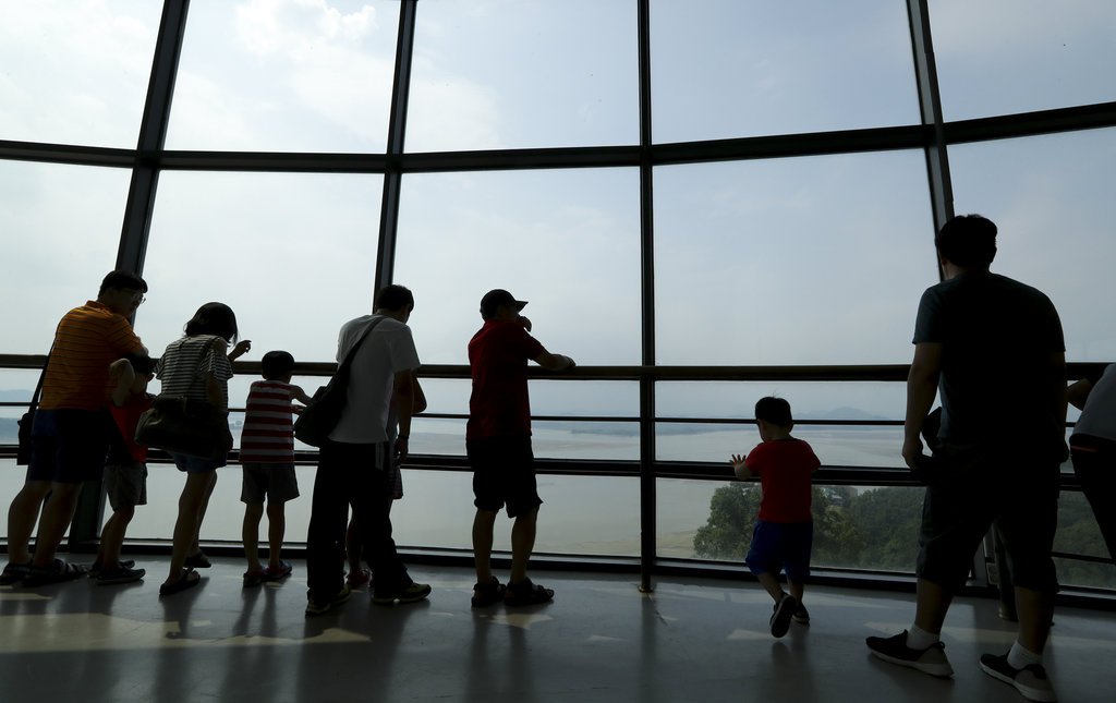 Visitors watch the North side from the unification observatory in Paju South Korea Sunday Aug. 6 2017. The U.N. Security Council unanimously approved tough new sanctions Saturday to punish North Korea for its escalating nuclear and missile programs