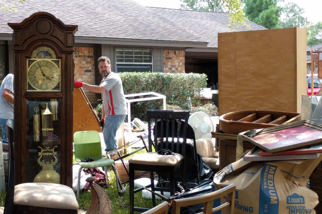 Sydney Truss hauled his ruined belongings out of his home which flooded as Harvey dumped more than 50 inches of rain in some parts of Texas