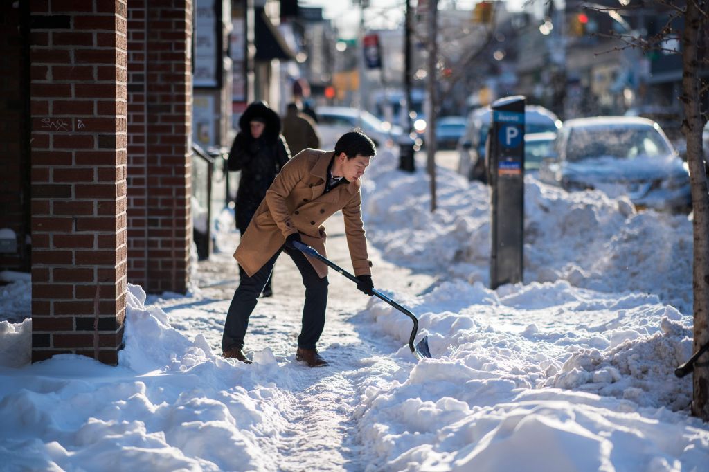 A man shovels snow from a footpath in New York City.
  Jewel Samad    
  AFP  Getty Images