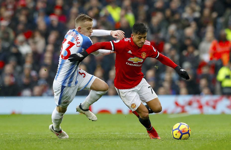 Huddersfield Town's Florent Hadergjonaj left and Manchester United's Alexis Sanchez during their English Premier League soccer match at Old Trafford in Manchester England Saturday Feb. 3 2018