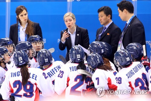 Sarah Murray head coach of the joint Korean women's hockey team  instructs her players during a timeout in their Group B contest of the women's hockey tournament against Switzerland at the Pyeong Chang Winter Olympics at Kwandong H