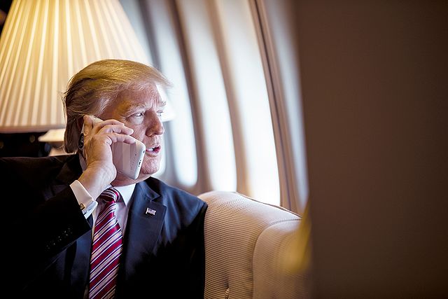 President Donald Trump talks on the phone aboard Air Force One. Credit The White House from Washington DC