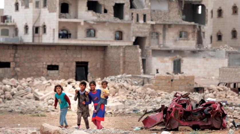 Children in front of a destructed building in al Bab city north of Syria. AP