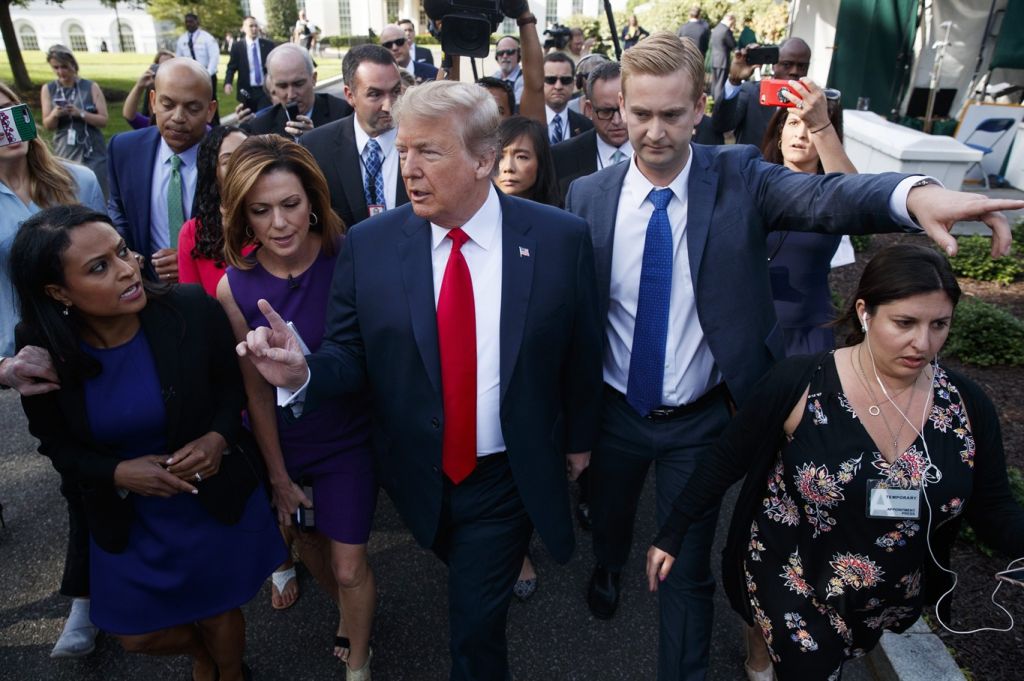 President Donald Trump walks to an interview on the North Lawn of the White House Friday