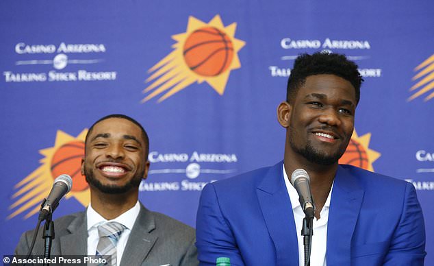 Phoenix Suns Mikal Bridges left and Deandre Ayton right laugh as they answer a question as the team introduces their NBA basketball draft picks Friday