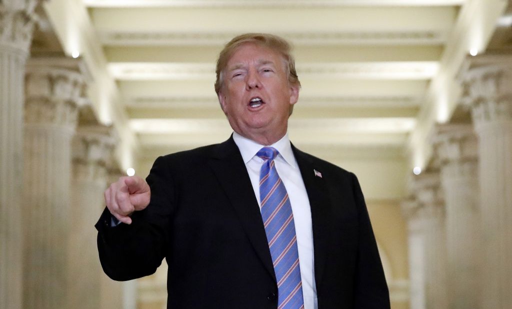 US President Donald Trump speaks in the Hall of Columns as he arrives on Capitol Hill in Washington