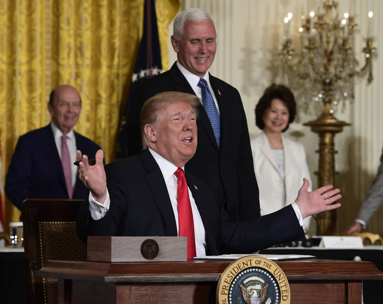 President Donald Trump gestures as he signs a “Space Policy Directive” during a meeting of the National Space Council in the East Room of the White House Monday