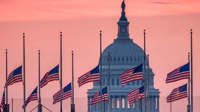 Flags flying a half-staff in honor of Sen. John McCain R-Ariz. frame the U.S. Capital at daybreak in Washington Sunday Aug. 26 2018. McCain 81 died at his ranch in Arizona after a yearlong battle with brain cancer