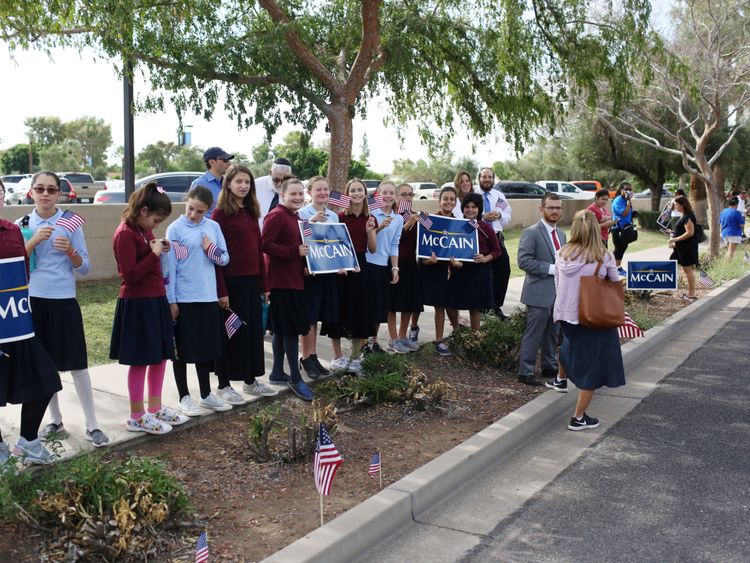 People lined the motorcade route as Mr McCain's casket was taken to the Phoenix church