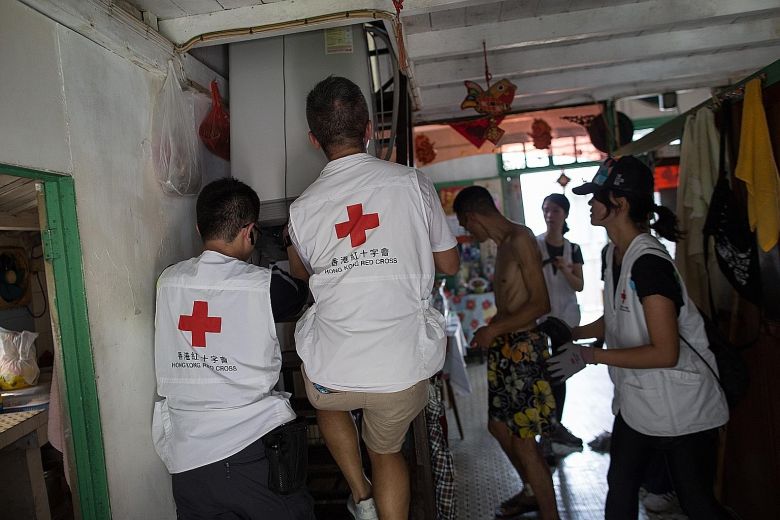 Volunteers helping residents to move their furniture to higher ground in Tai O village on Lantau Island Hong Kong yesterday. Evacuations have begun for some Tai O residents ahead of the arrival of super typhoon Mangkhut