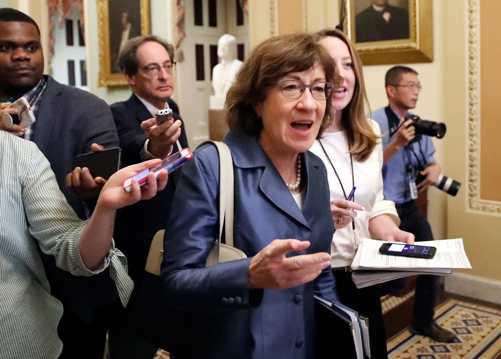 Sen. Susan Collins R-Maine center walks with journalists as she departs the Republican policy luncheon on Capitol Hill on Tuesday in Washington. She reiterated to reporters that she believes Supreme Court nominee Brett Kavanaugh would not favor overtur