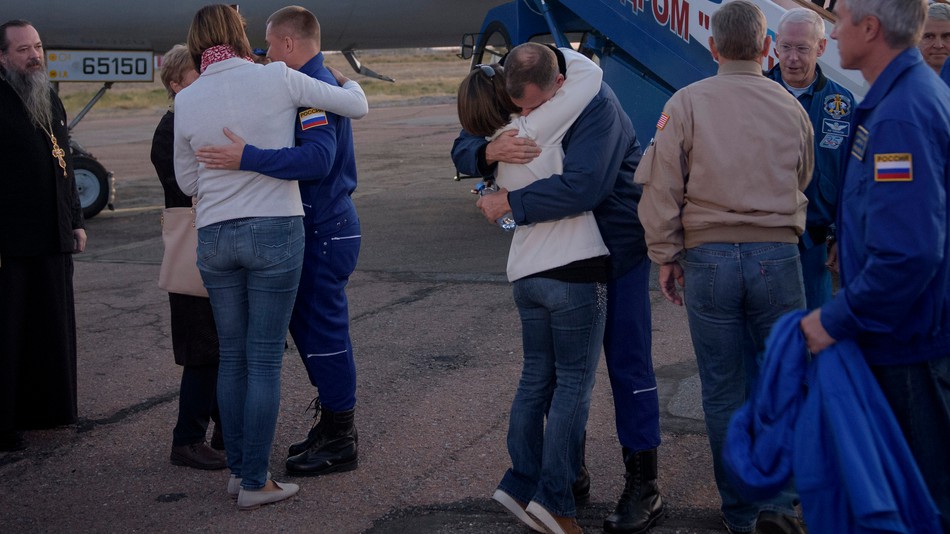 NASA astronaut Nick Hague and Russian cosmonaut Alexey Ovchinin with their families after coming home